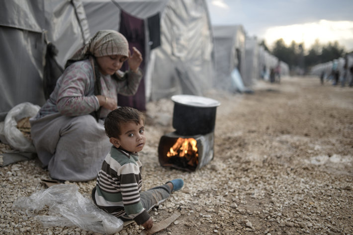 Syrian family in a refugee camp in Turkey, 2015 ( photo by By Orlok Shutterstock.com)  